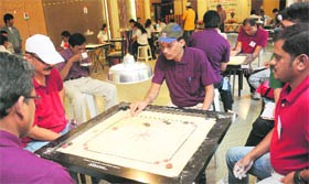 Players in action during a match of the All-India Public Sector Carrom Tournament at Hotel Parkview in Chandigarh.