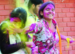 Girls celebrate the festival of colours in New Delhi on Tuesday.