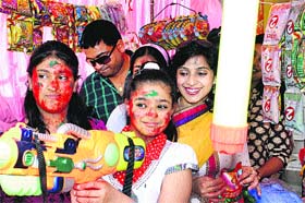 With Holi just a day away, children try out water guns and colours at a shop in Model Town, Rohtak on Tuesday