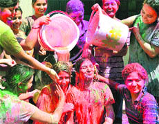 On the eve of the festival of colours, college students celebrate Holi in Jalandhar. 