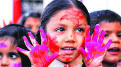 School children celebrate Holi with dry colour in Jalandhar on Tuesday.