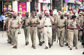 Police officials take out a flag march on the eve of Holi in Ludhiana on Tuesday