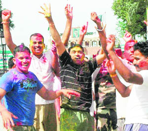 BSF jawans and official play Holi at the Wagah Barder, Amritsar, on Wednesday.