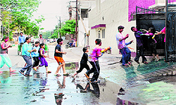 Children drench each other with coloured water on Holi in Bathinda