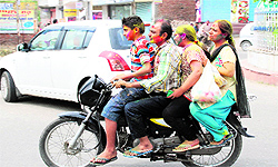 A family takes a joy ride on a motorbike flouting the traffic rules