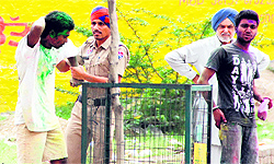 A policeman takes a youth to task for rowdy behaviour