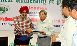 CUP VC Dr Jai Rup Singh (left) shakes hands with an official of the National Agri-Food Biotechnology Institute, Mohali, after signing the agreement in Bathinda on Thursday