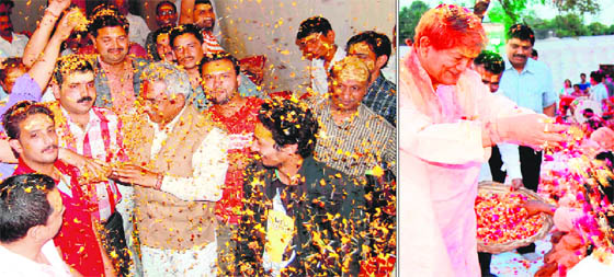 Former state minister and Haridwar legislator Madan Kaushik plays Holi with flowers with his supporters on Wednesday; and (right) Union Water Resource Minister Harish Rawat celebrating Holi with saints of Haridwar.