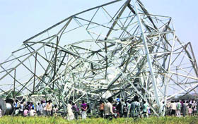 Residents throng the collapsed transmission tower in Mewat on Thursday.