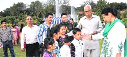 Governor NN Vohra and his wife Usha Vohra celebrate Holi with children at Raj Bhawan in Jammu on Wednesday. A tribune Photo
