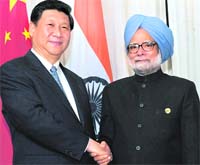 Prime Minister Manmohan Singh with Chinese President Xi Jinping at the BRICS Summit in Durban on Wednesday.  PTI 