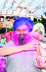 Devotees play with Holi colours at Anandpur Sahib. 