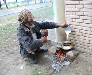 A man prepares his meal on an earthen chulha before beginning his daily chores in Bathinda on Friday.