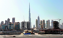 Construction cranes near the 163-storey Burj Khalifa, the worlds tallest building (C), in Dubai. A little over three years after a corporate debt crisis drove it to the brink of default, Dubai is still littered with relics of the disaster, in the form of unfinished projects and battered balance sheets