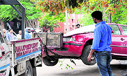 A recovery van tows away a car parked on the MC land at the Sector 28 motor market in Chandigarh on Friday