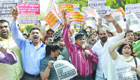 Delhi Cable TV operators shout slogans during a protest against the government policies, at Jantar Mantar in New Delhi on Friday.