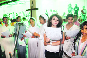 Members of the Christian community pray at a church in Dehradun on Good Friday. 