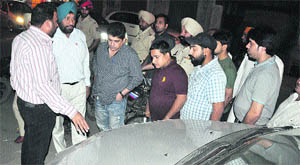 A crowd gathered near the broken car in Jalandhar on Friday. 