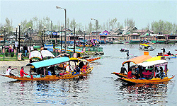 Tourists enjoy shikara rides on the Dal Lake in Srinagar on Friday