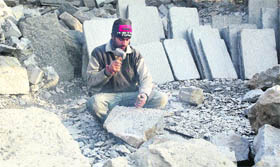 A man carves out sculptures from a stone in Srinagar on Friday.