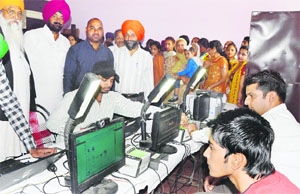 Aadhaar cards being made at a camp in Aman Nagar. 