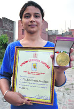 Khushmeet with her medal and citation.