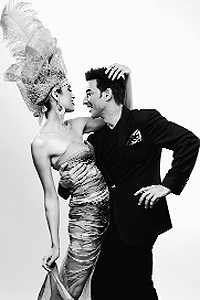 The designer with a model wearing one of his creations