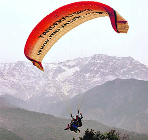 Tourists enjoy paragliding in Dharamsala on Saturday. 