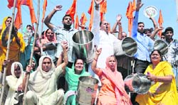 Activists of Dogra Front and Shiv Sena beat empty utensils to protest against shortage of ration in Jammu on Saturday. Tribune photo: Inderjeet Singh