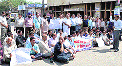 Shopkeepers sit on a dharna in protest against the imposition of property tax at the Gobindgarh Mahla Market and (right); a view of a closed market on the SD College road in Jalandhar on Saturday