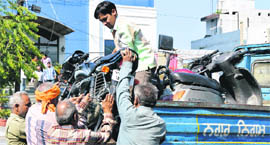 MC staff confiscate two-wheelers outside Friends Regency Hotel in Ludhiana on Saturday.