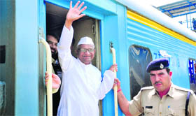 Anna Hazare waves at his supporters at the Ludhiana railway station on Saturday.
