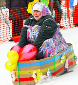 A participant competes during the 8th annual comic tobogganing competition from a snow slope on basins, baths, refrigerators and other items, dedicated to the upcoming All Fools' Day and the end of a winter sports season at Krasnoyarsk in Russia on Saturday.