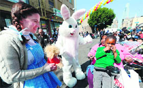 The Easter bunny greets children before the Skid Row Easter event at the Los Angeles Mission in California on Friday. Volunteers, celebrities and nurses distributed over 1,000 Easter baskets to children and provided 3,500 hot meals, 2,000 pairs of shoes and podiatric care to the homeless of the Skid Row.