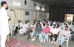 Jasbir Sahota, an ETT teacher, addresses a gathering over the government's move to merge primary schools with the better ones at the Teachers' Home on Sunday.