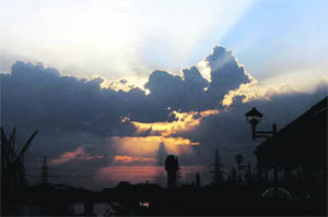 The sun sets behind the clouds near the GNDTP lakes in Bathinda.
