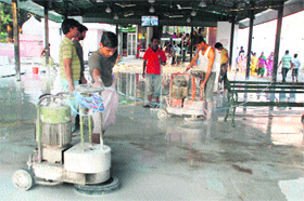 Workers clean the floor at the entrance to the Mansa Devi temple in Panchkula.
