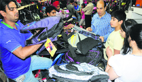 A parent buys school bags for his children at Sector 19 in Chandigarh.