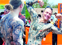 A foreigner flaunts his tattoos during a KTM sports bikes racing event near IGI Airport in New Delhi on Sunday