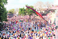 Devotees erect Jhanda Sahib at Sri Guru Ram Rai Darbar during Jhanda Mela in Dehradun on Sunday.
