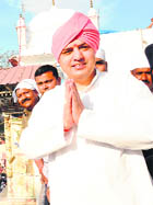 Mahant Devender Dass greets devotees.