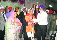 Chief Justice AK Sikri being presented a siropa by Gurdwara Parbandhak Committee president Kulwant Singh at the Paonta Sahib gurdwara on Sunday.