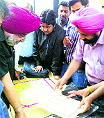 Pushpa Gujral Science City (PGSC) Director General Dr RS Khandpur watches a project during a maths training programme at (PGSC) in Kapurthala
