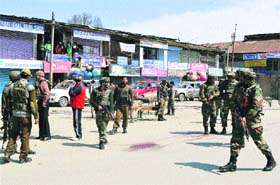 Security personnel inspect the spot where militants opened fire on a police patrol party last week at Sopore in Baramulla