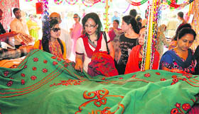 Women purchase clothes at the annual Police-Public Mela in Jammu on Sunday.