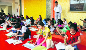 Students participate in a painting competition organised at the Police Auditorium in Jammu on Sunday.