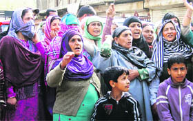 Residents of Bemina Hamadana Colony stage a protest against power shortage in their area, in Srinagar on Sunday.