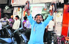 A man is all smiles after buying liquor from a vend in Ludhiana on Sunday