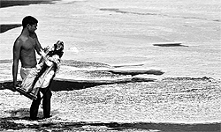 A man immerses an idol of a goddess in the Yamuna at Kalindi Kunj in Noida on Sunday
