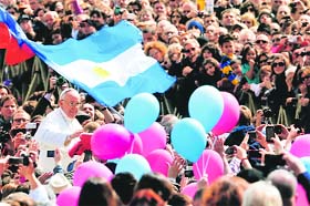Pope Francis (L) waves at the end of the Easter mass at St Peter's Square in the Vatican on Sunday
